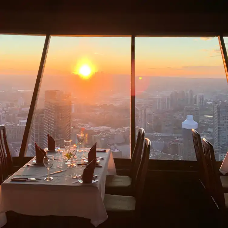 A sunset view from 553 feet in the sky at Top of Vancouver Revolving Restaurant, one of the best view restaurants in Vancouver.