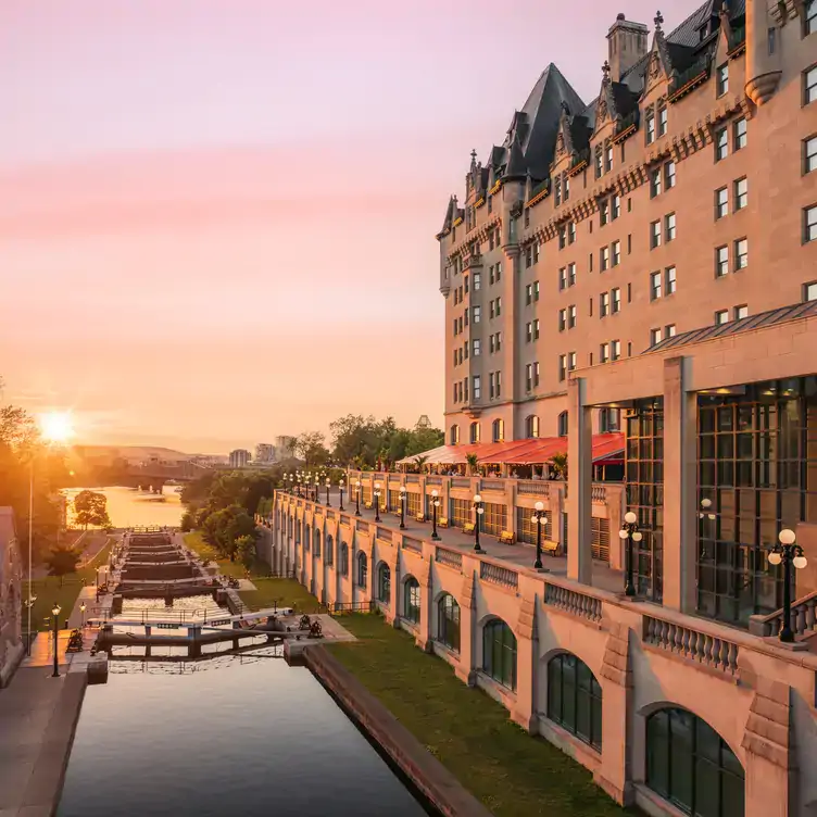 A sunset over the Ottawa River and the Chateau Laurier at La Terrasse, one of the best restaurants with a view in Ottawa.