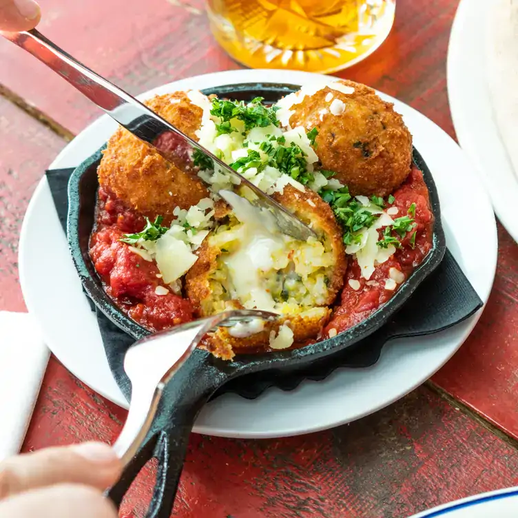 Arancini rice balls with tomato sauce at Pie Bar Pizzeria, one of the best Harbourfront restaurants Toronto offers.