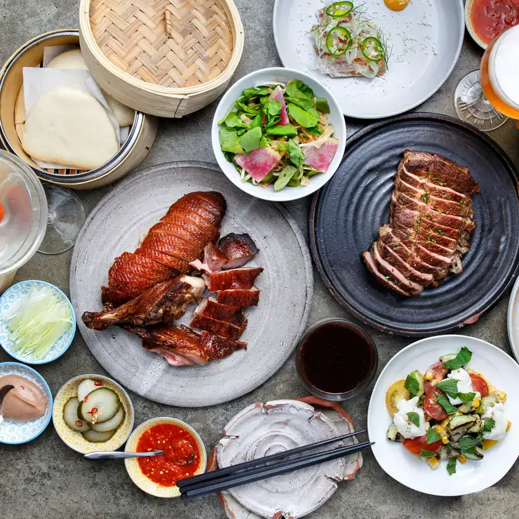 A selection of Chinese appetizers including crispy dusk and condiments, from the menu at Torafuku, one of the best Chinese restaurants in Vancouver.