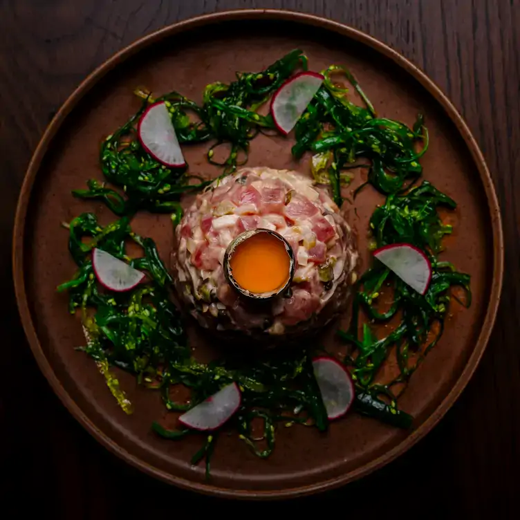 A French dish surrounded by greens and radish, from the menu at Merèon Bistro, one of the best restaurants in West Vancouver.