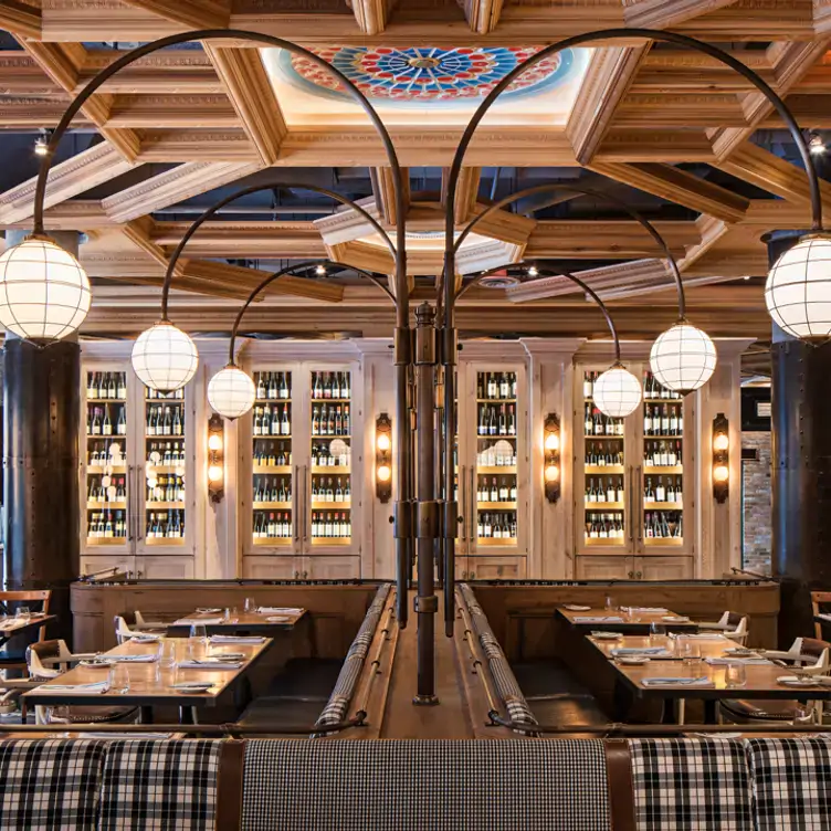 Tables and a wall of wine racks under a domed roof at Cluny, one of the best restaurants in the Distillery District in Toronto.