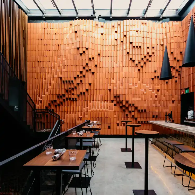 Terracotta walls and a bar at Gusto 501 in Toronto