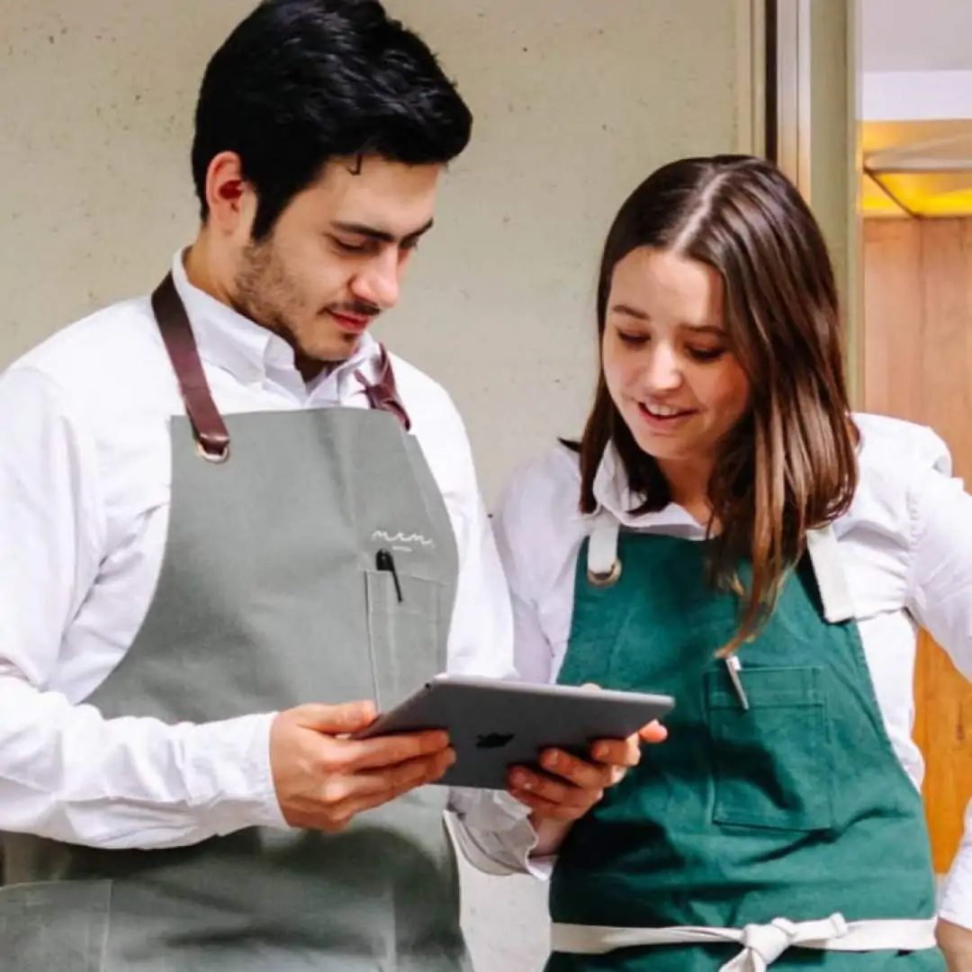 restaurant workers looking at ipad