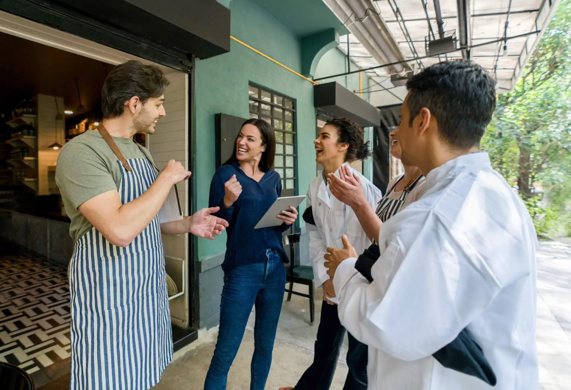 A restaurant team assembles for a pre-shift meeting